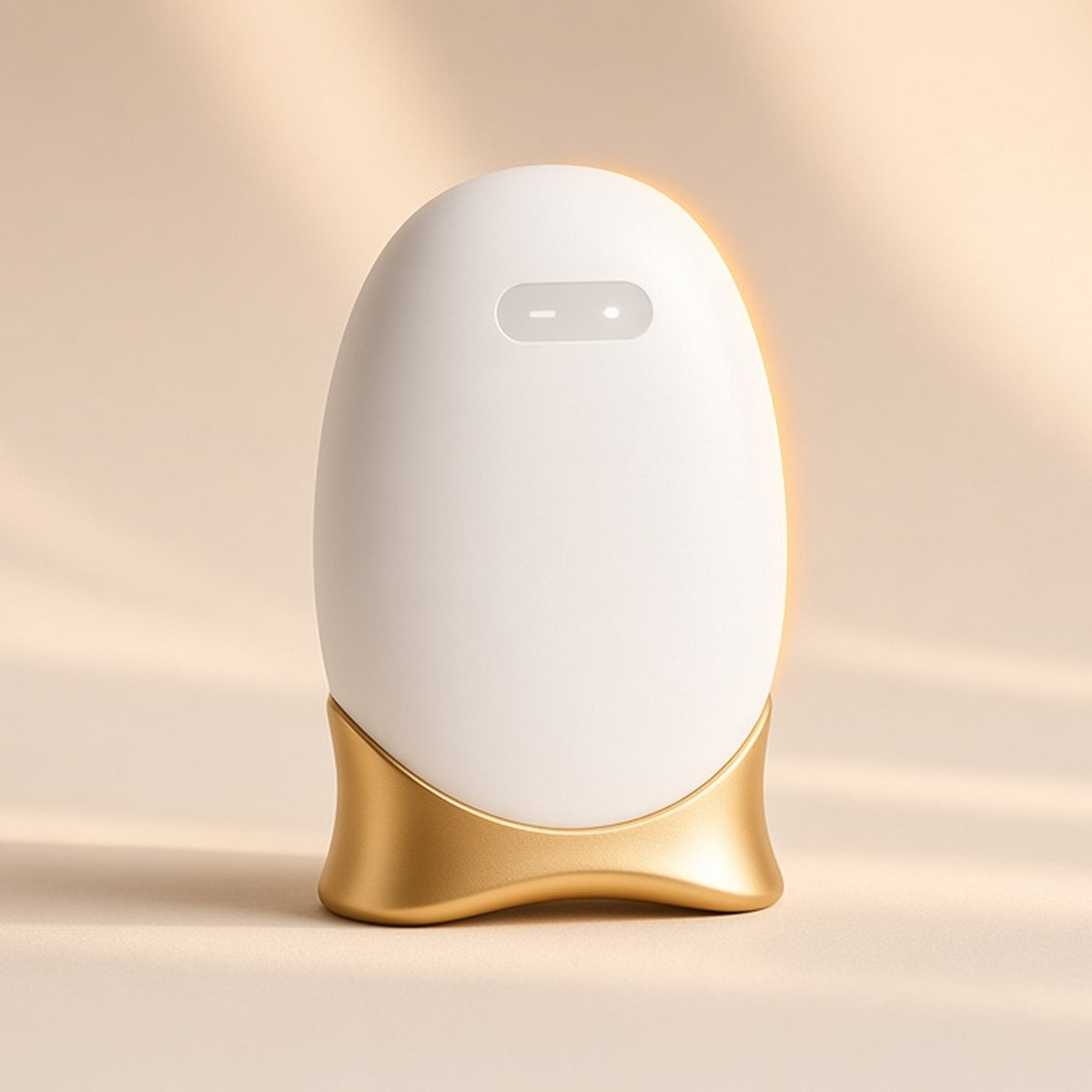 Halo warm gua sha, white rounded body with gold contoured base, on a seamless cream backdrop